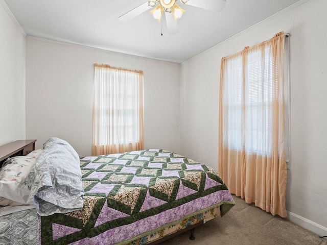 bedroom featuring crown molding, baseboards, ceiling fan, and carpet flooring