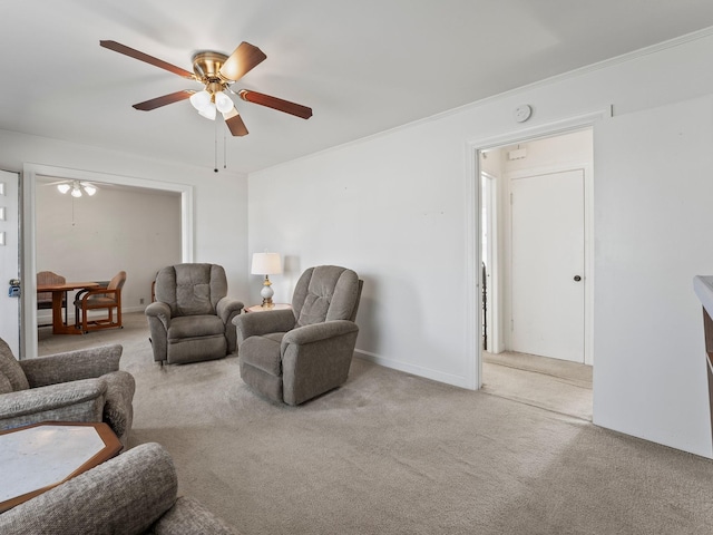 carpeted living area featuring a ceiling fan