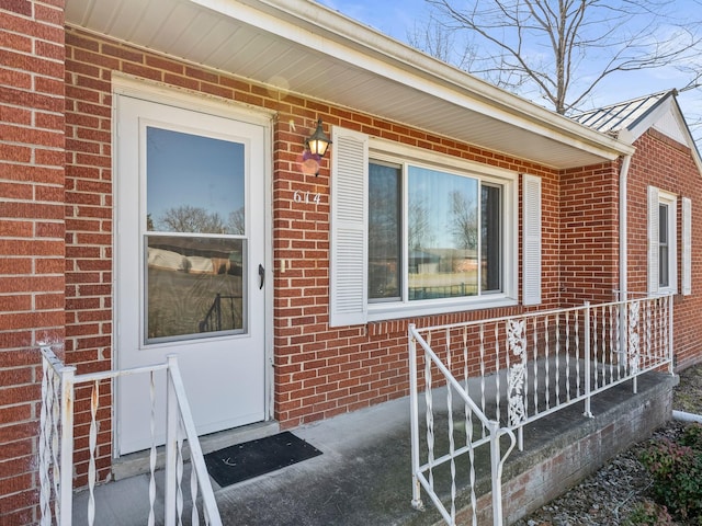 property entrance featuring brick siding