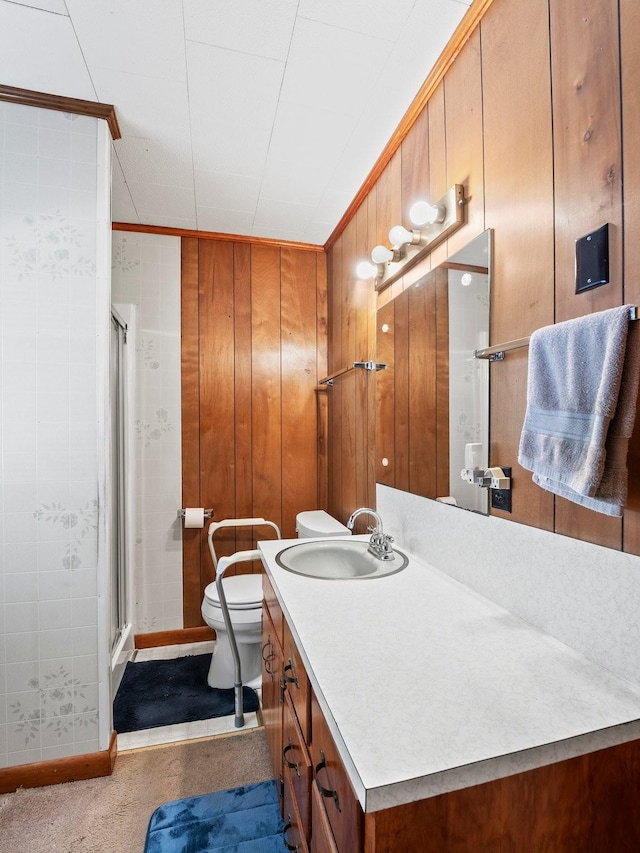 full bathroom featuring toilet, a shower stall, crown molding, and vanity