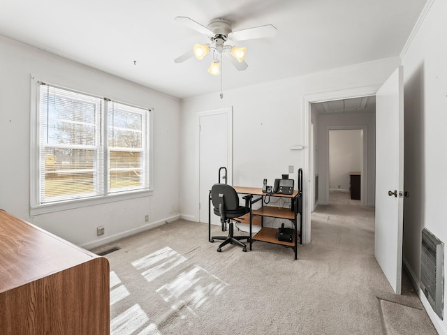 office space featuring attic access, light colored carpet, visible vents, and heating unit