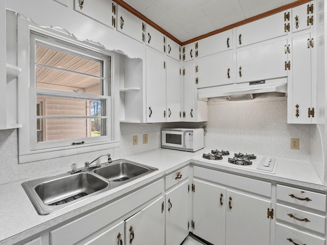 kitchen featuring light countertops, white appliances, a sink, and under cabinet range hood