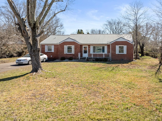 view of front of house featuring metal roof, a porch, brick siding, crawl space, and a front lawn