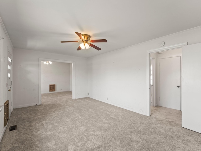 empty room featuring light carpet, visible vents, and a ceiling fan