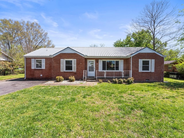 ranch-style home featuring crawl space, metal roof, a front lawn, and brick siding