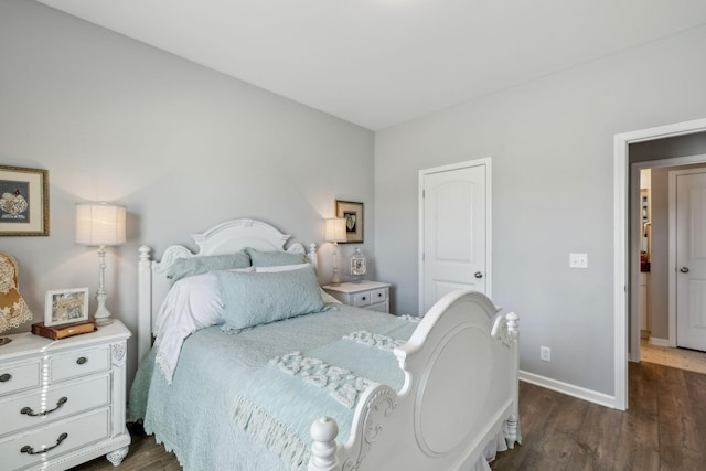 bedroom with dark wood-style floors and baseboards