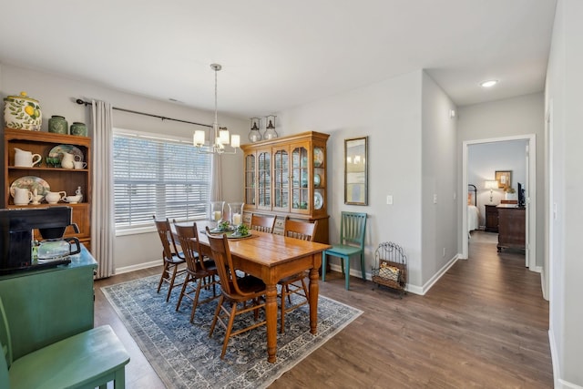 dining room with baseboards, a chandelier, wood finished floors, and recessed lighting