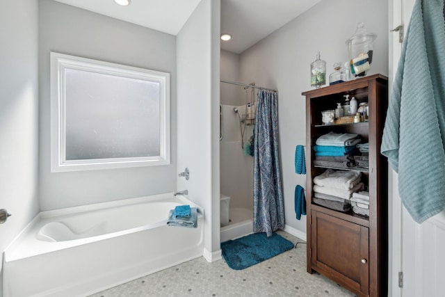 bathroom with a shower stall and a bath