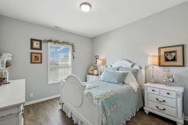 bedroom with dark wood-style floors, baseboards, and visible vents