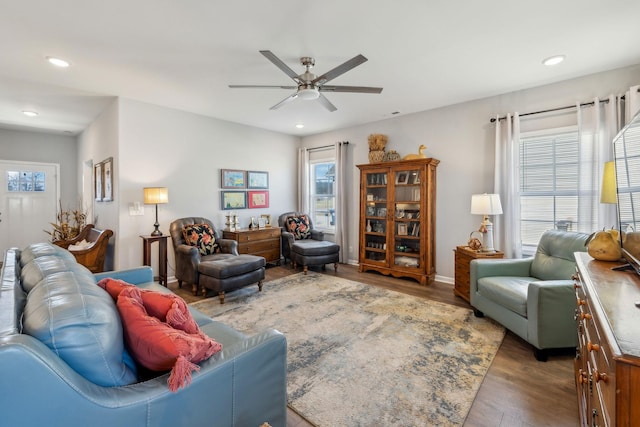 living room featuring wood finished floors, a ceiling fan, and recessed lighting