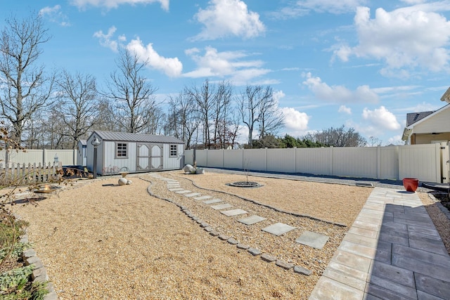 view of yard featuring a storage shed, a fenced backyard, and an outdoor structure