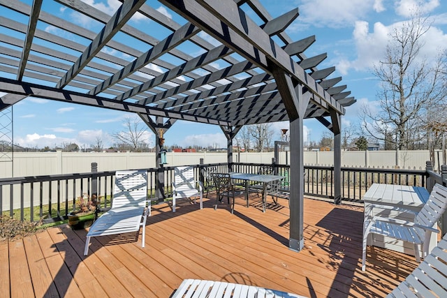 wooden deck with a fenced backyard, outdoor dining area, and a pergola