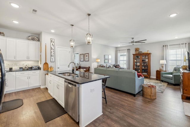 kitchen featuring open floor plan, visible vents, a sink, and dishwasher