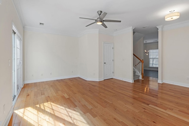 unfurnished room featuring visible vents, stairway, ornamental molding, light wood-type flooring, and baseboards