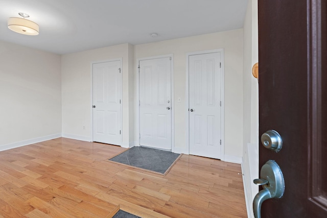 entrance foyer featuring light wood-style flooring and baseboards