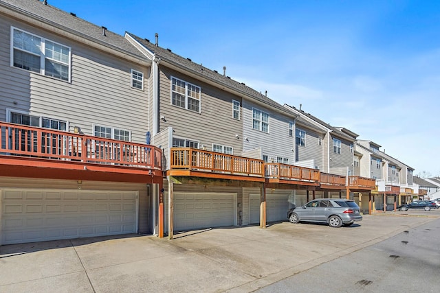 back of house with an attached garage and a residential view