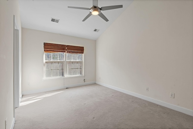 carpeted empty room with vaulted ceiling, visible vents, ceiling fan, and baseboards