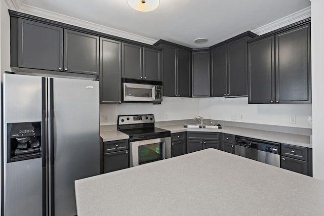 kitchen with stainless steel appliances, light countertops, and a sink