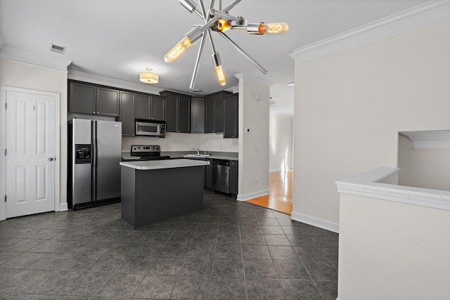 kitchen featuring visible vents, a kitchen island, appliances with stainless steel finishes, ornamental molding, and a sink