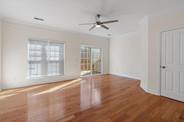 unfurnished room with ornamental molding, baseboards, and hardwood / wood-style flooring