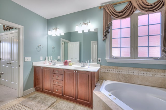 bathroom with a bath, double vanity, a sink, and tile patterned floors