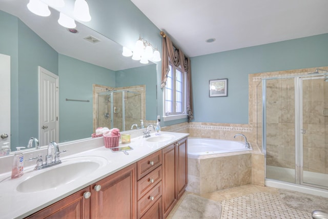 bathroom with a stall shower, visible vents, a sink, and a garden tub