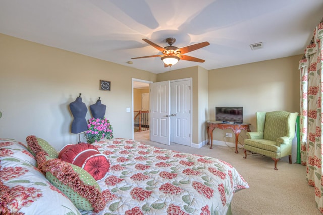 carpeted bedroom with baseboards, a closet, visible vents, and a ceiling fan