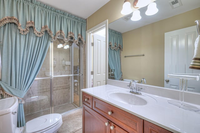 full bath with toilet, vanity, a shower stall, and visible vents