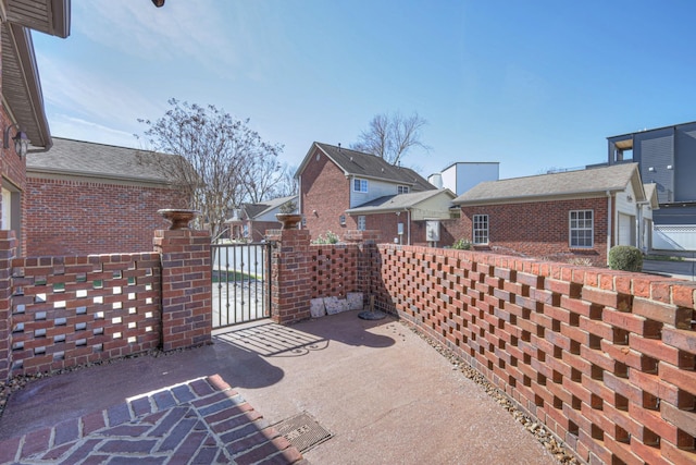 view of patio / terrace with a gate and a residential view