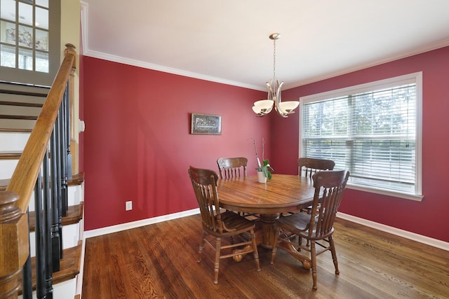 dining space featuring baseboards, a notable chandelier, ornamental molding, and wood finished floors