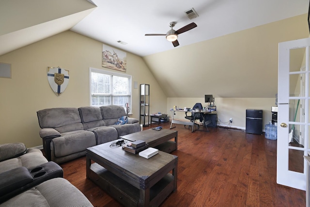 living room featuring lofted ceiling, visible vents, and wood finished floors