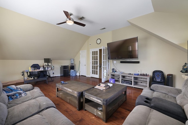 living area with ceiling fan, visible vents, vaulted ceiling, and wood finished floors