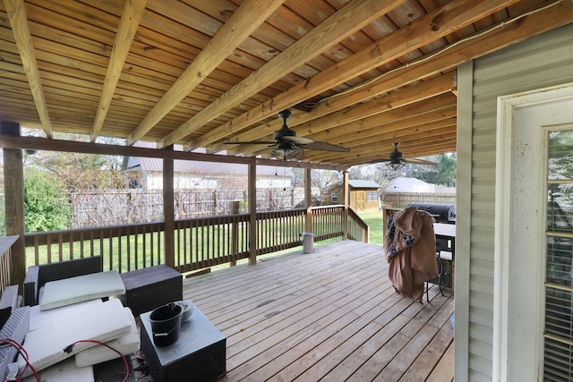 deck with ceiling fan, area for grilling, and fence