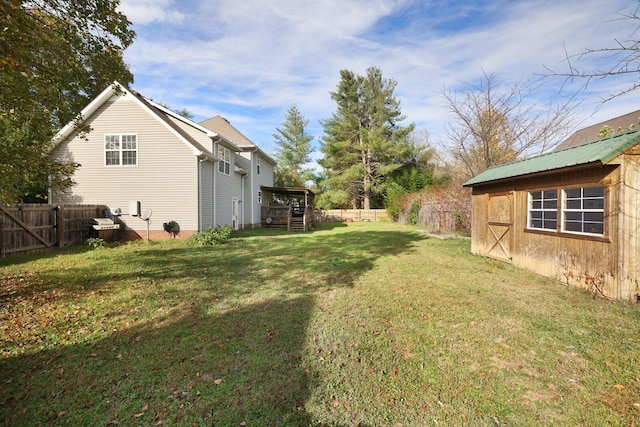 view of yard featuring an outbuilding and a fenced backyard