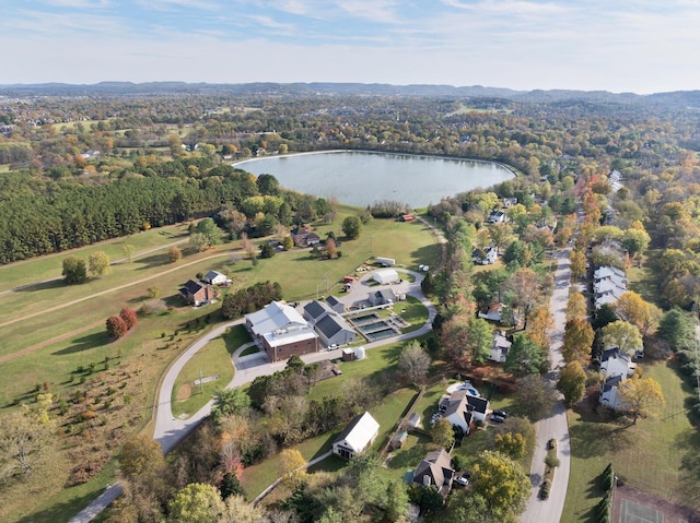 birds eye view of property with a water view and a view of trees