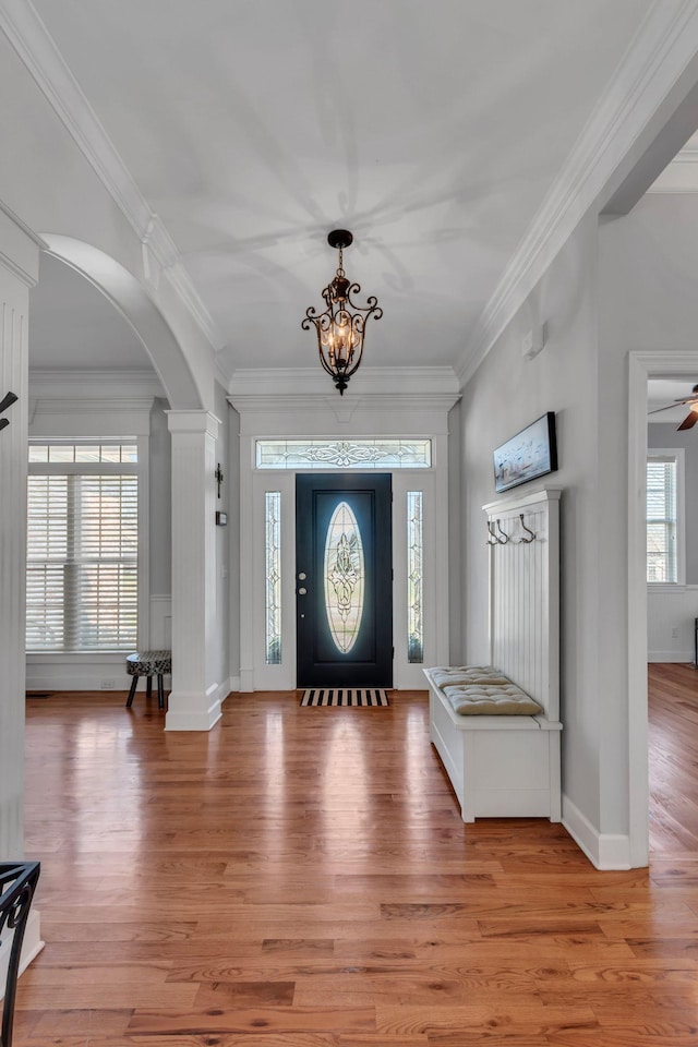 entryway featuring light wood-type flooring and crown molding