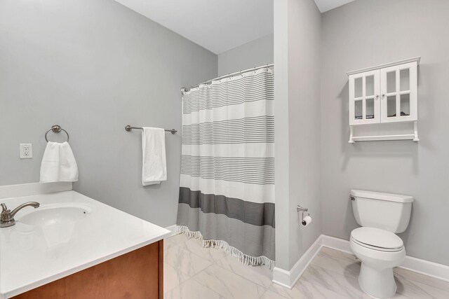 bathroom with marble finish floor, a shower with shower curtain, toilet, vanity, and baseboards