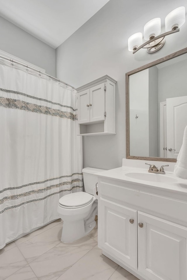 full bathroom with marble finish floor, vanity, and toilet