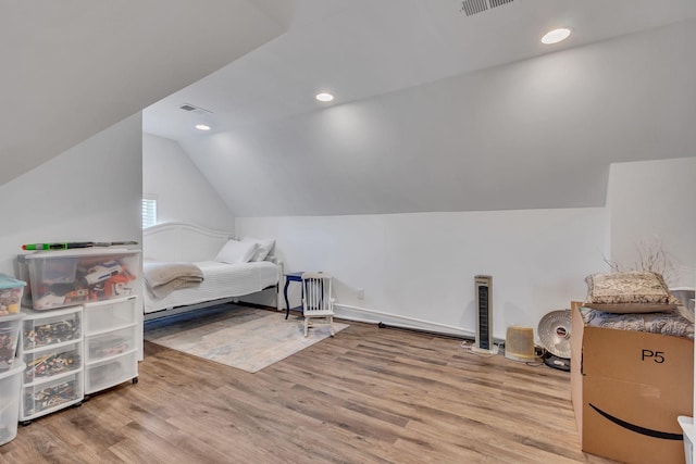 bedroom featuring lofted ceiling, visible vents, wood finished floors, and recessed lighting