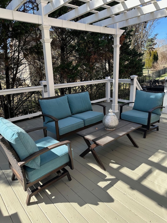 deck featuring an outdoor living space and a pergola