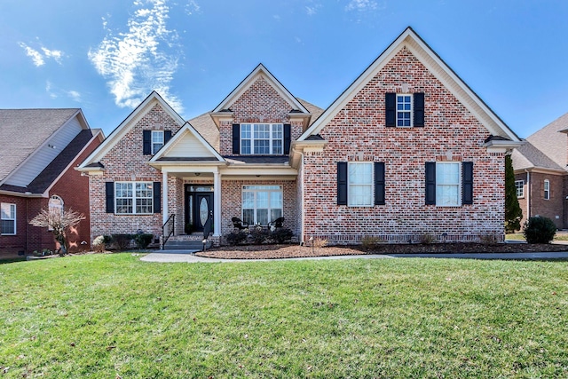 view of front of home featuring brick siding and a front lawn