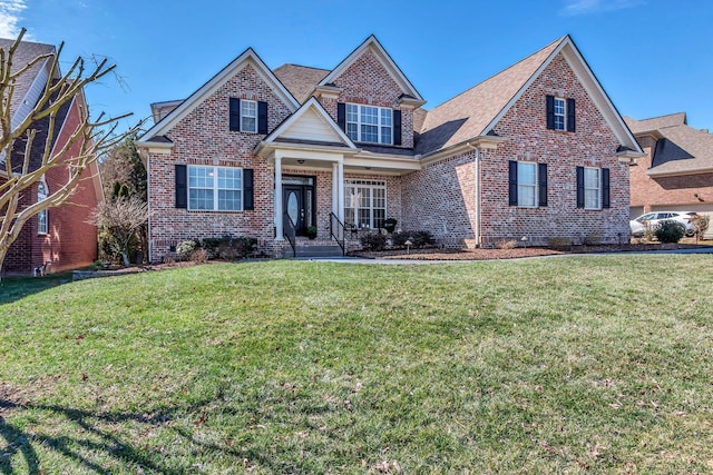 view of front of house featuring brick siding and a front lawn