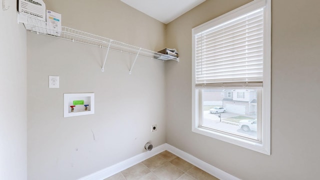 clothes washing area featuring laundry area, light tile patterned floors, baseboards, washer hookup, and electric dryer hookup