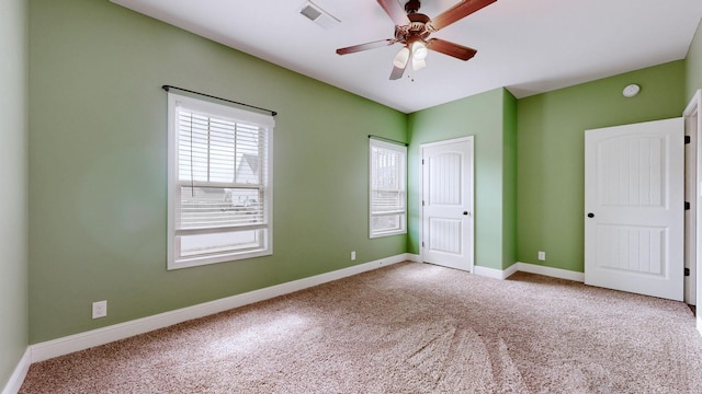 unfurnished room with a ceiling fan, baseboards, visible vents, and carpet flooring