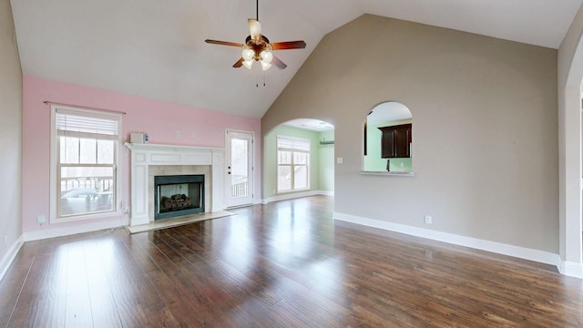 unfurnished living room featuring dark wood-style flooring, a fireplace, a ceiling fan, and baseboards