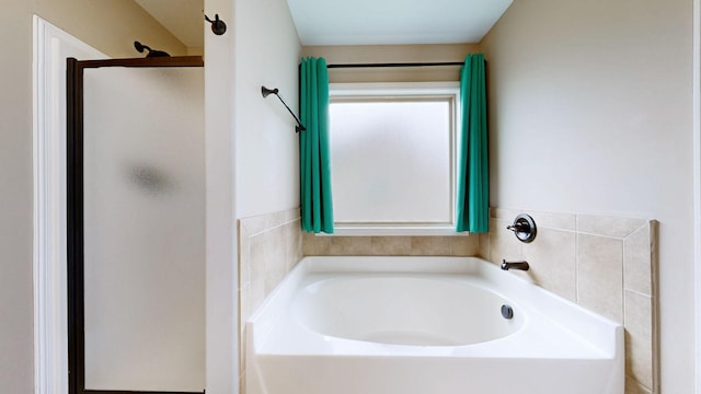 full bath featuring a shower stall and a bath