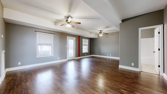 unfurnished living room featuring a ceiling fan, baseboards, and wood finished floors