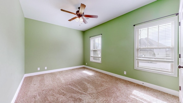 unfurnished room featuring carpet floors, baseboards, and a ceiling fan