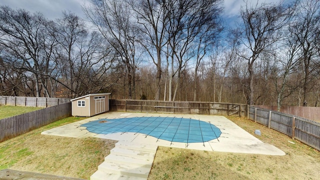 view of pool featuring a patio area, an outdoor structure, a fenced backyard, and a fenced in pool