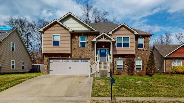 split foyer home featuring brick siding, central AC unit, a front yard, a garage, and driveway